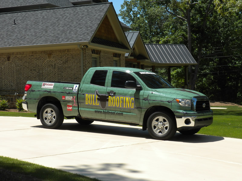 Bull Roofing service truck in front of a home